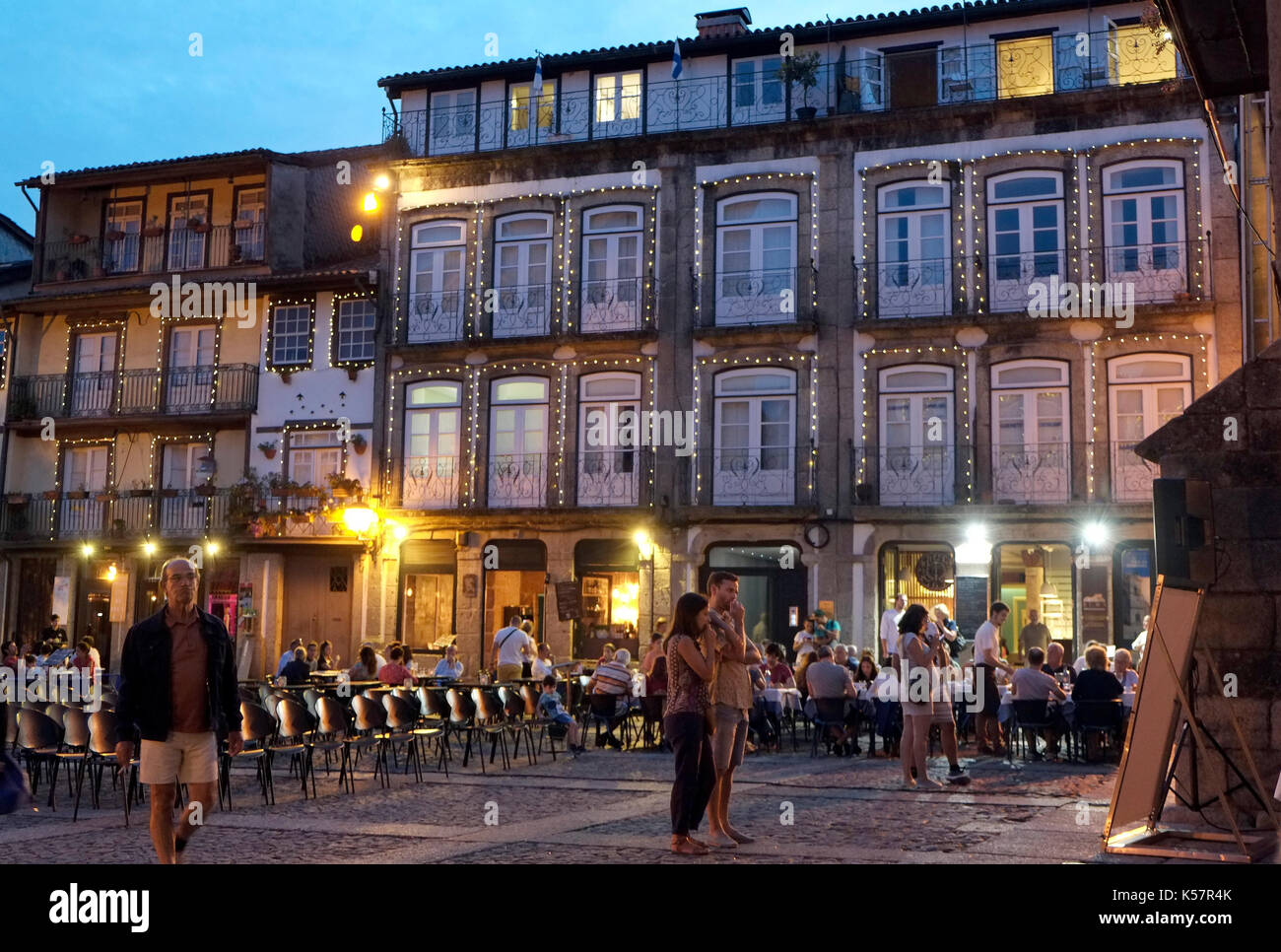 Tourists and local residents watch a free showing of a Charlie Chaplin film in the town square of Guimaraes, in Portugal August 22, 2017. © John Voos Stock Photo