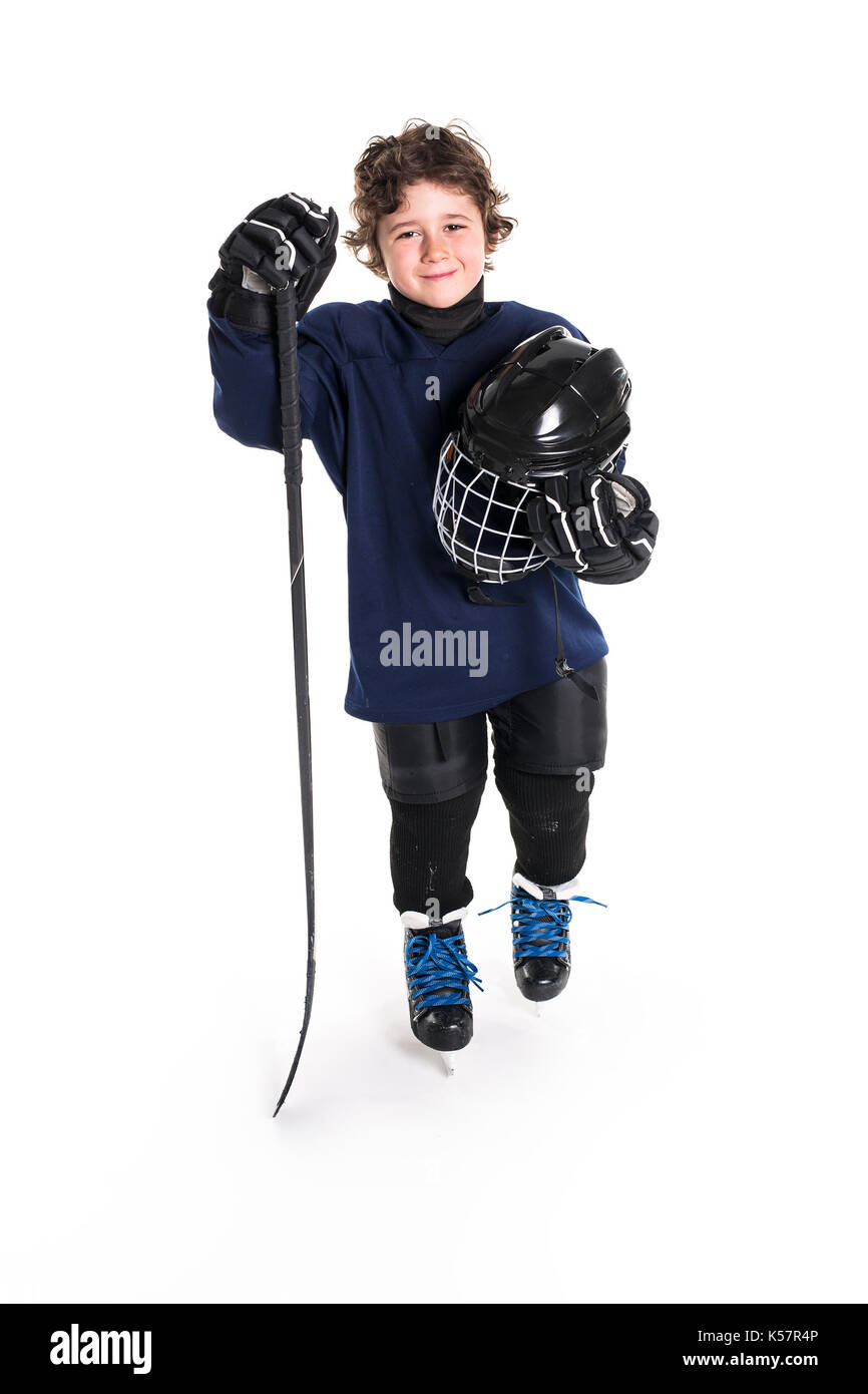 Young boy in ice hockey gear against white Stock Photo