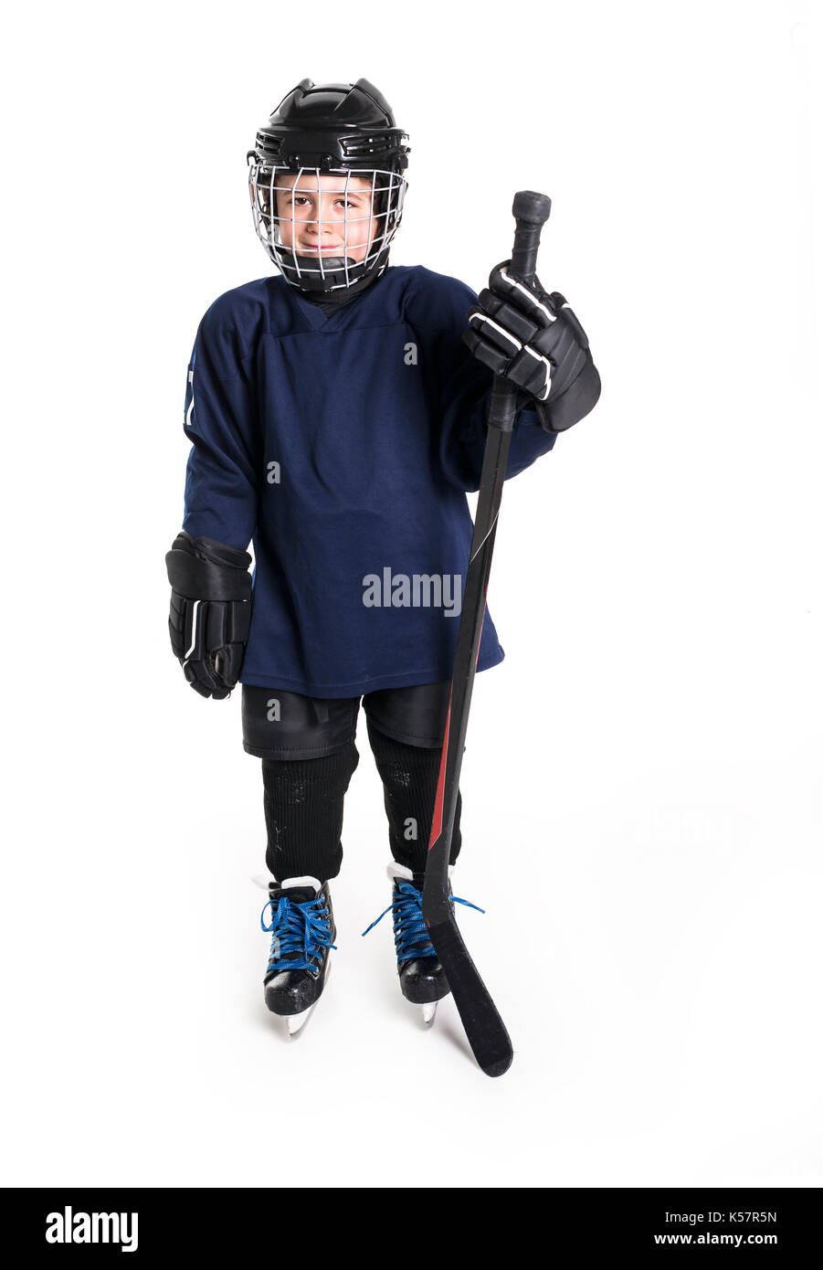 Young boy in ice hockey gear against white Stock Photo