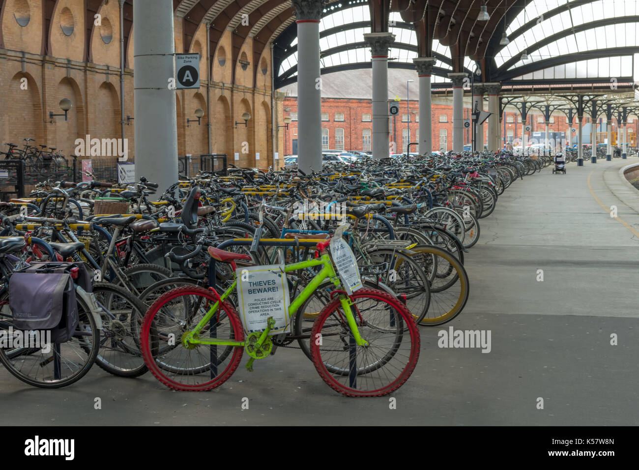 Cycle rack at York Station with police warning signs. Stock Photo