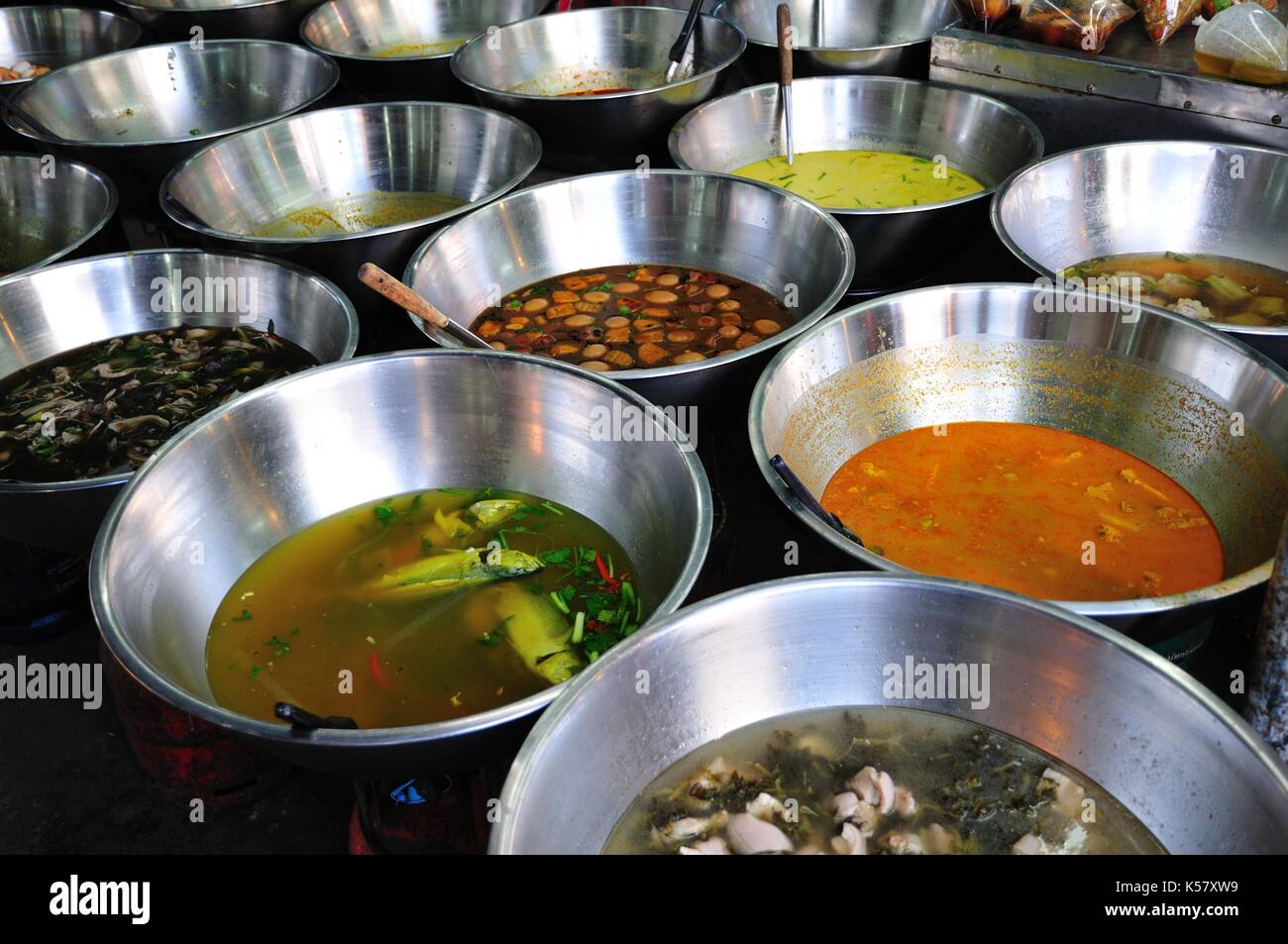 Delicious dishes in stainless steel containers on Thai food market, Krabi, Thailand Stock Photo