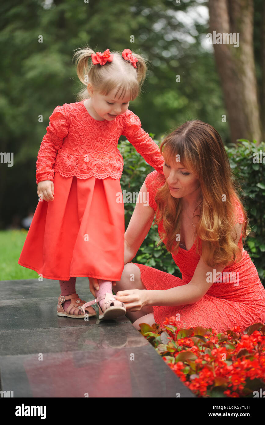 mom shoes young daughter in park Stock Photo