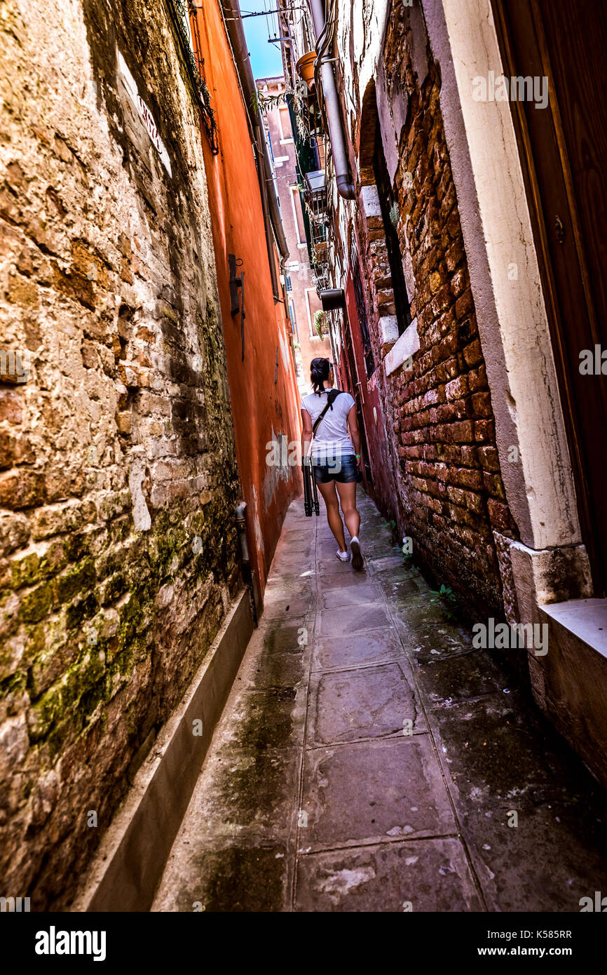 Woman walks through narrow hi-res stock photography and images - Alamy