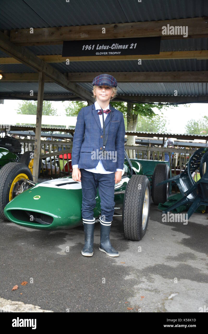 Young lad in flat cap, jacket and shirt hanging out posing in front of Lotus Climax;Goodwood Revival 8th Sept 2017 Stock Photo