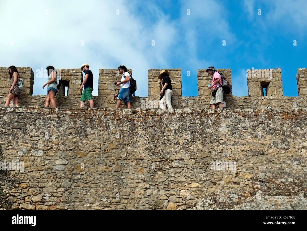 Tourists walk along the walls encircling the medieval town of Obidos, in Portugal August 24 , 2017. © John Voos Stock Photo