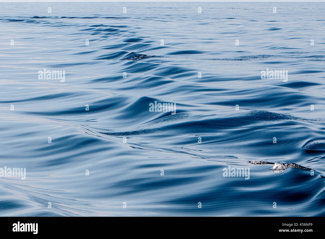 Boat wake on the ocean water surface. Stock Photo