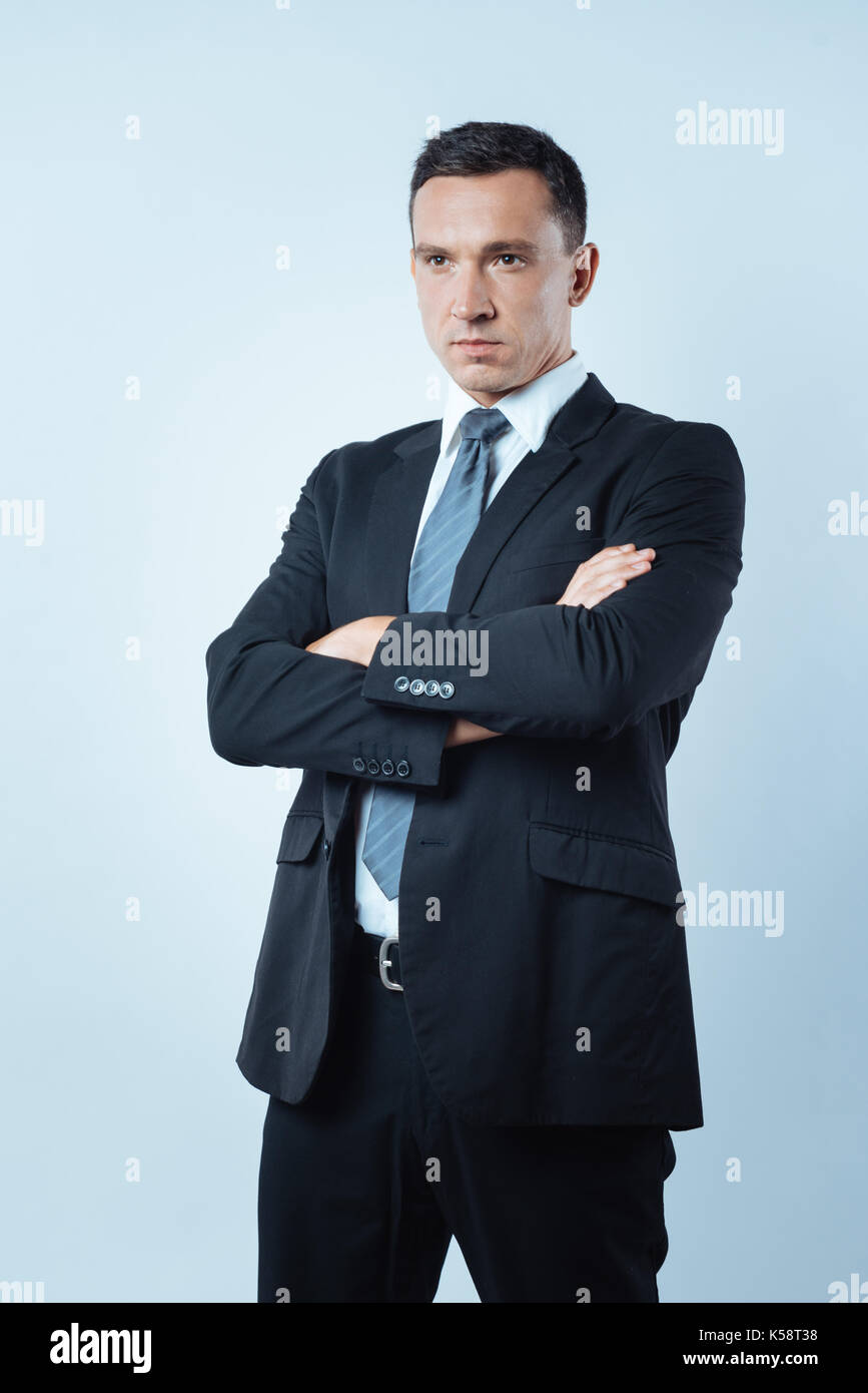 Serious smart businessman crossing his arms Stock Photo