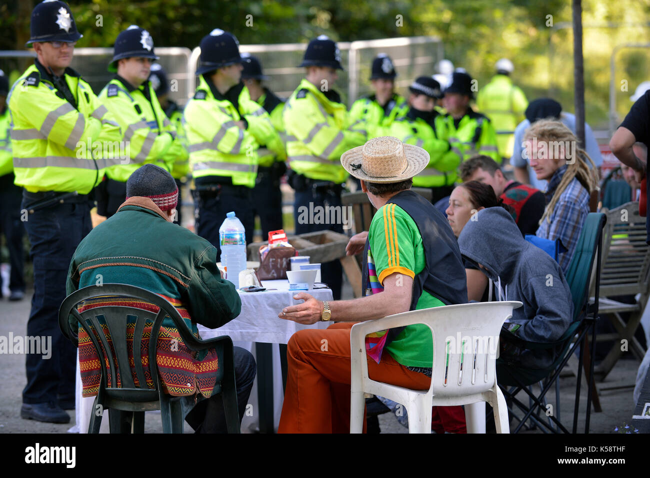 Protesters against fracking at Balcombe, Sussex take a break while the police look on. Credit Terry Applin Stock Photo