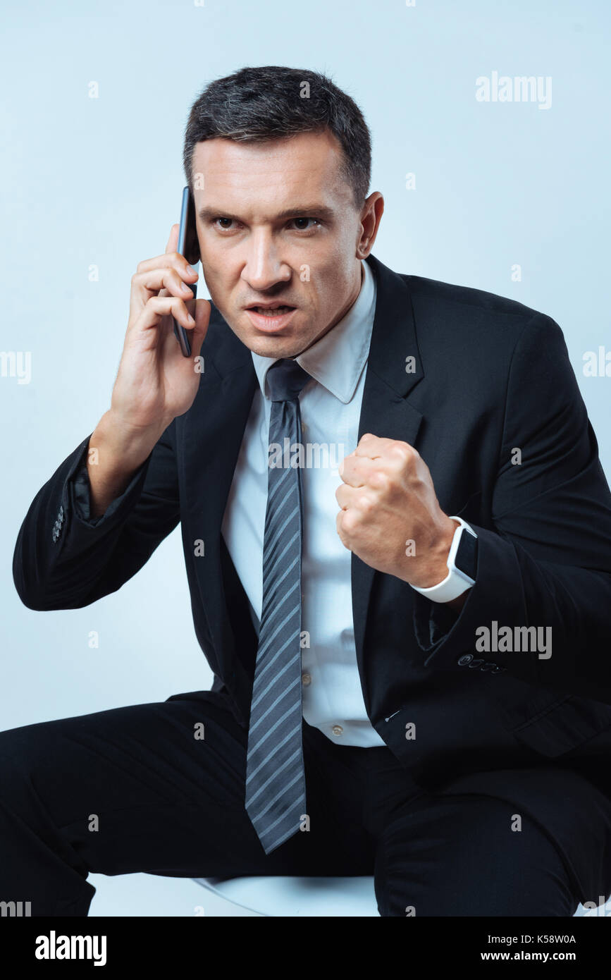 Angry adult man clenching his fist Stock Photo