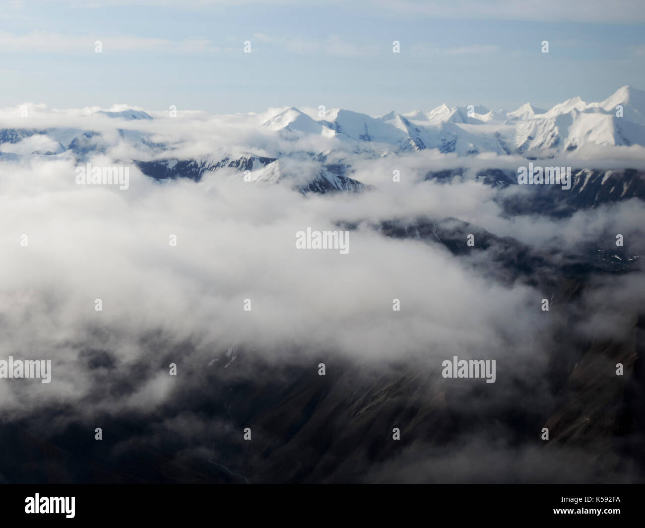 AERIAL VIEW OF SNOW CAPPED MOUNTAINS AND CLOUDS, ALASKA Stock Photo - Alamy