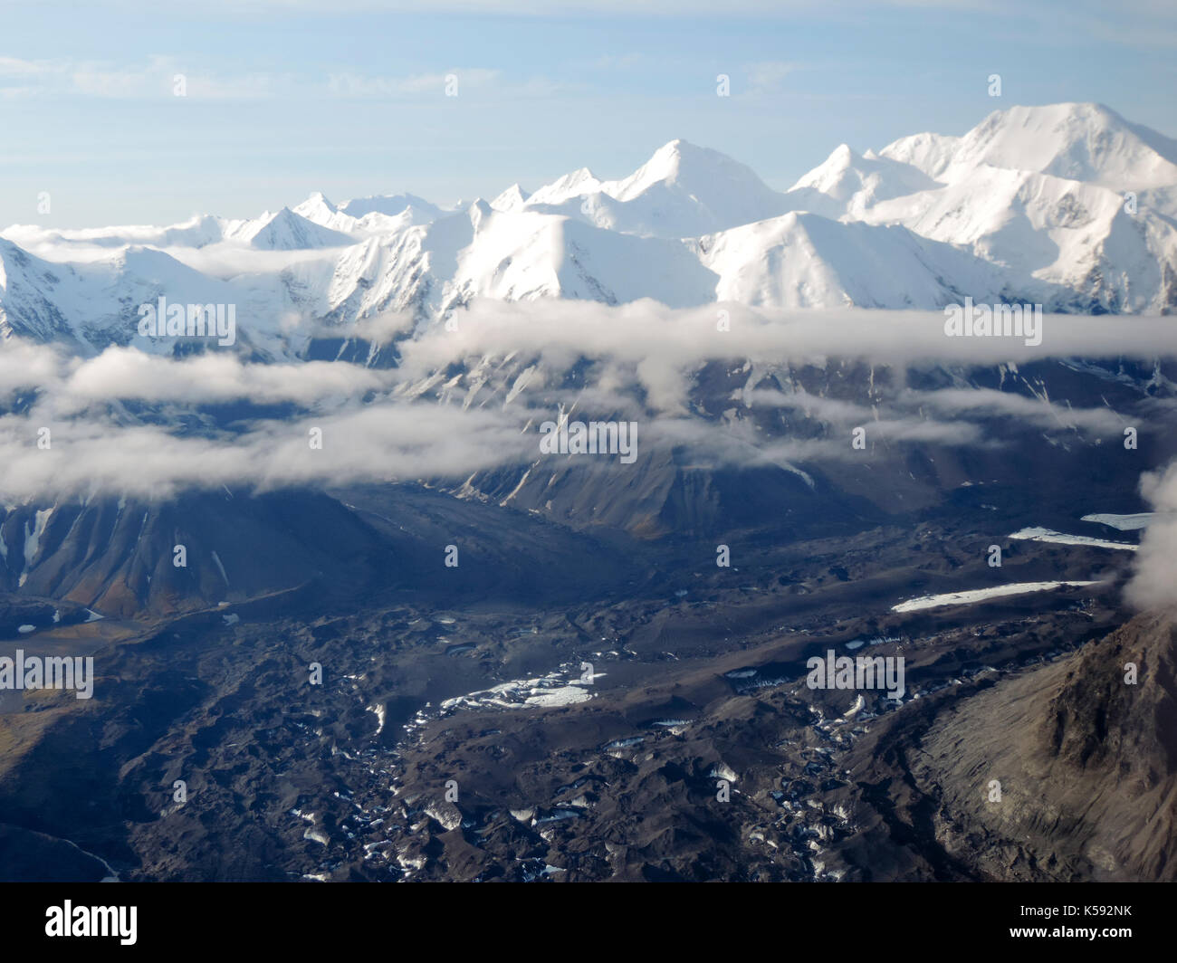 AERIAL VIEW OF SNOW CAPPED MOUNTAINS AND CLOUDS, ALASKA Stock Photo - Alamy