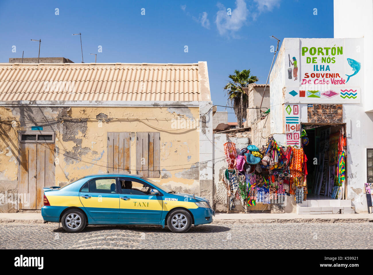 CAPE VERDE SAL Taxi cab driving down the main street past a local souvenir shop,  Praca Central, Santa Maria, Sal island, Cape Verde, Africa Stock Photo