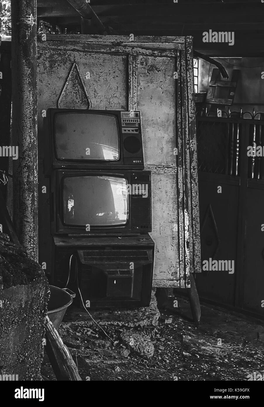 Vintage old television TV sets broken and ruined inside abandoned house Stock Photo