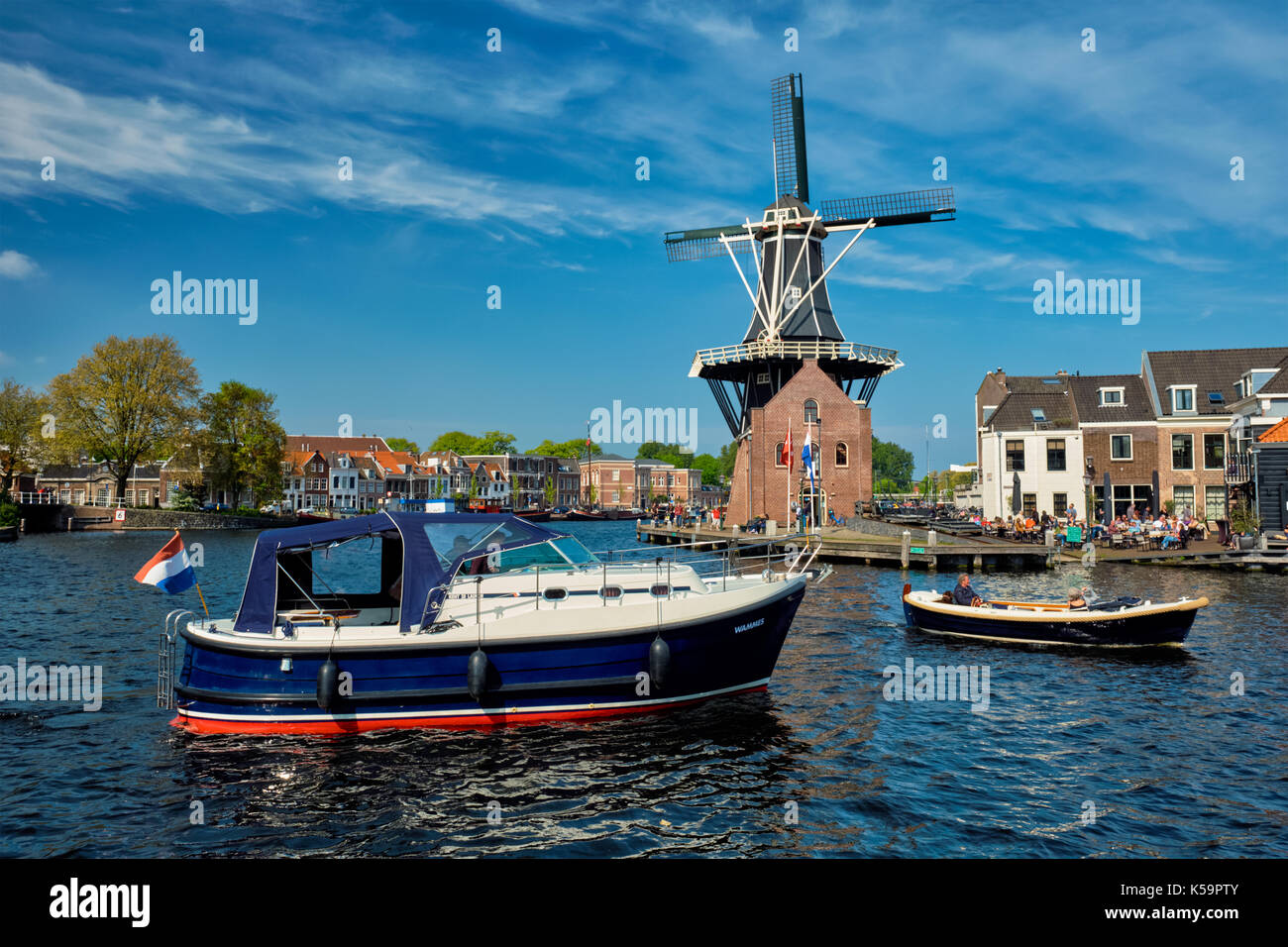 Harlem landmark  windmill De Adriaan and boat on Spaarne river.  Stock Photo