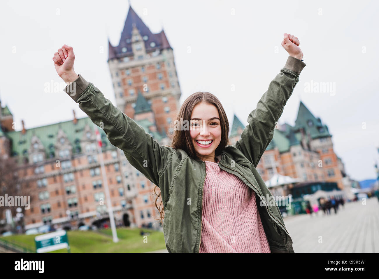 Quebec City scape with Chateau Frontenac and young teen enjoying the ...