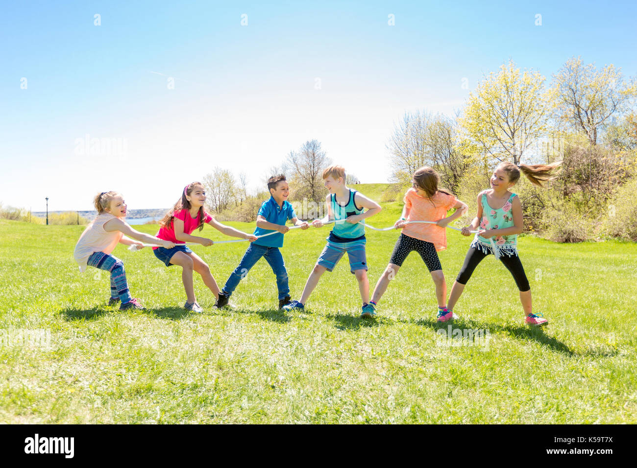 Group of child have fun on a field with rope Stock Photo