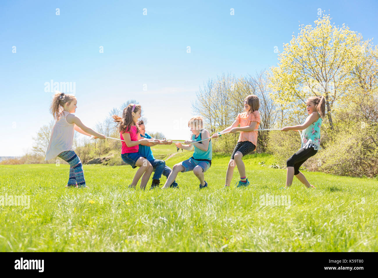 Group of child have fun on a field with rope Stock Photo