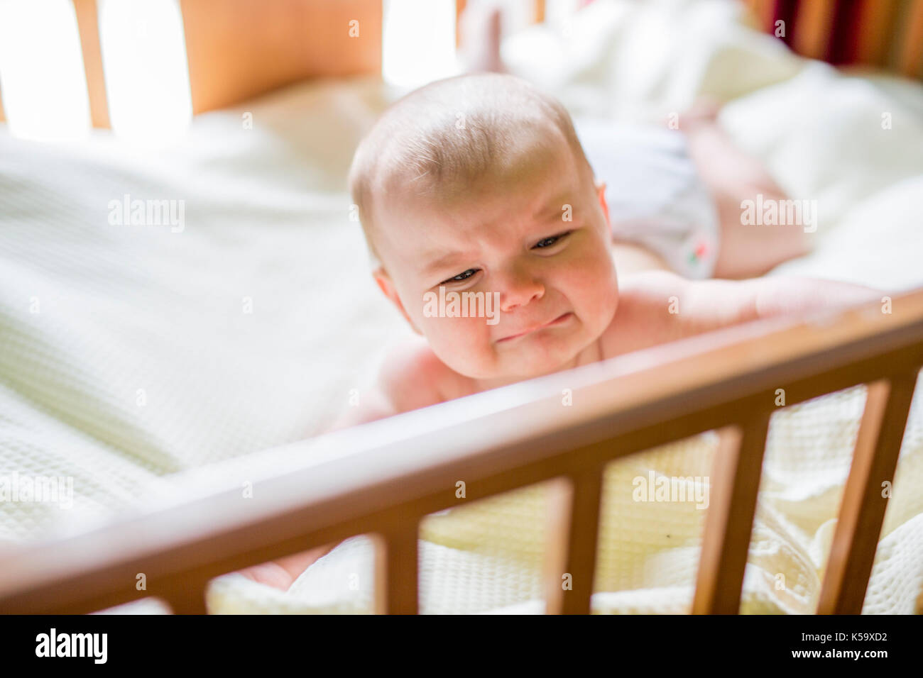 Baby crying in crib hires stock photography and images Alamy