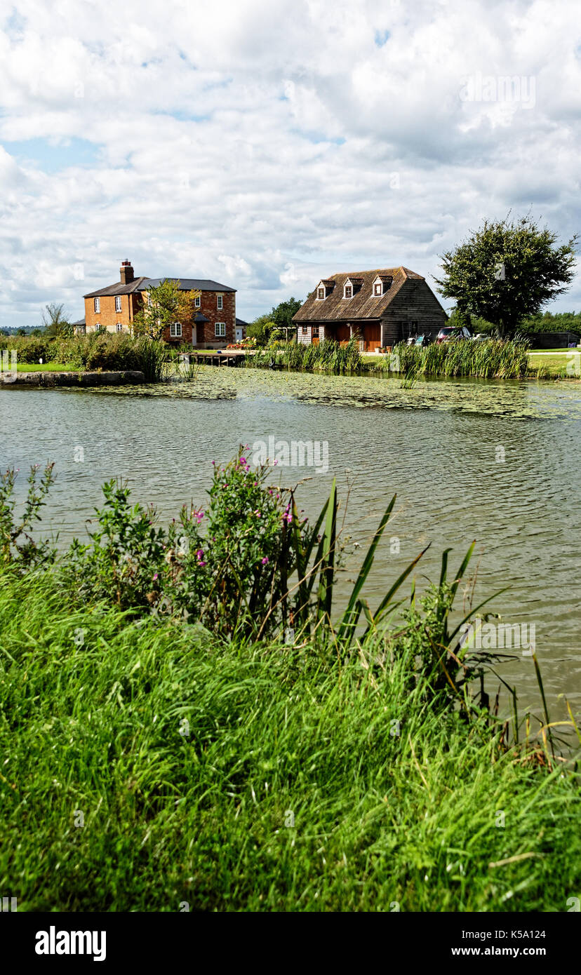 country style house on banks of canal. Stock Photo