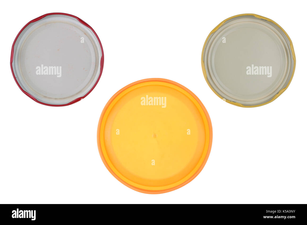 The reverse side of used tin and plastic covers from glass jars with canned vegetables. Isolated