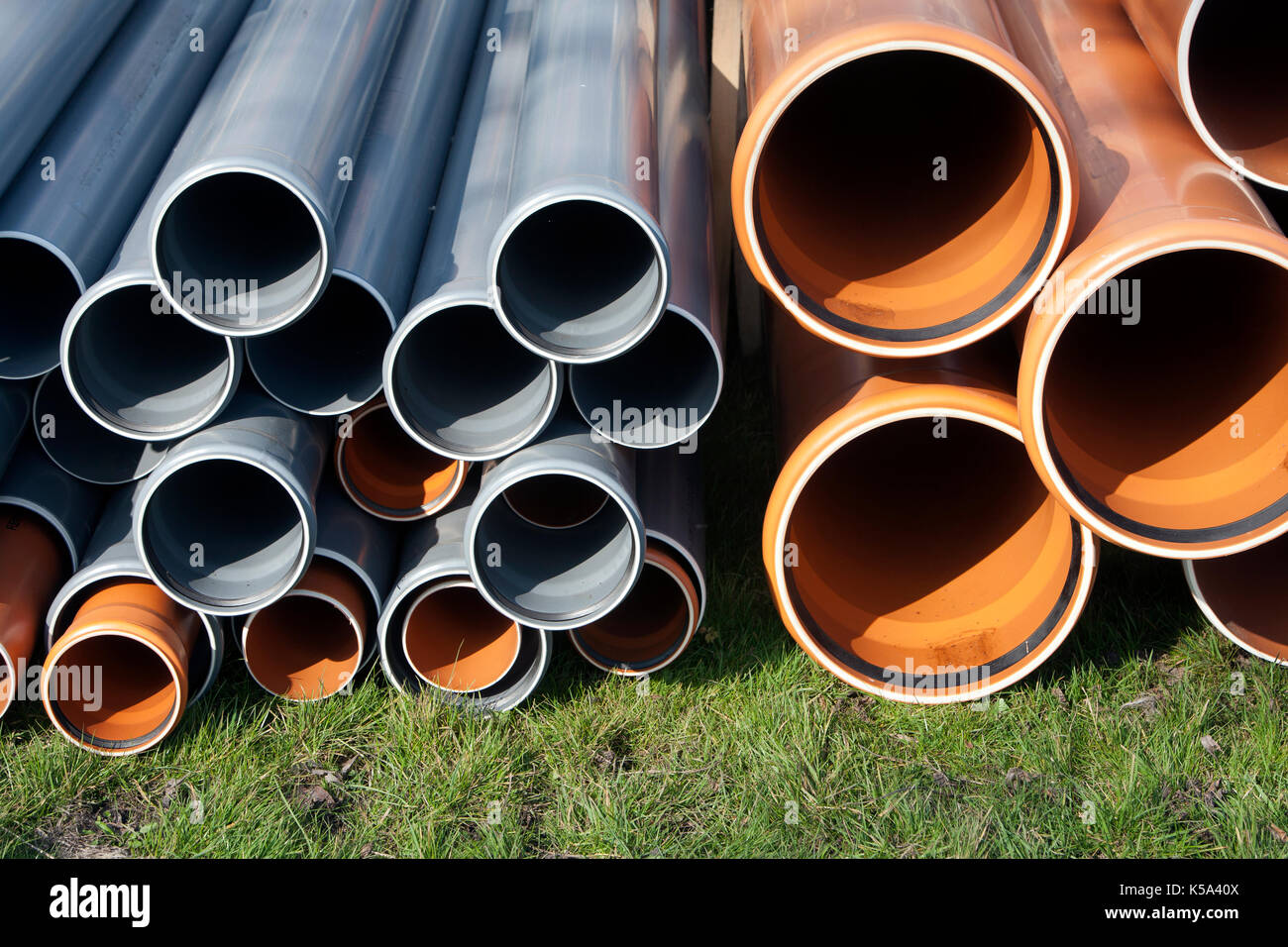 Drain pipes lying on a construction site Stock Photo