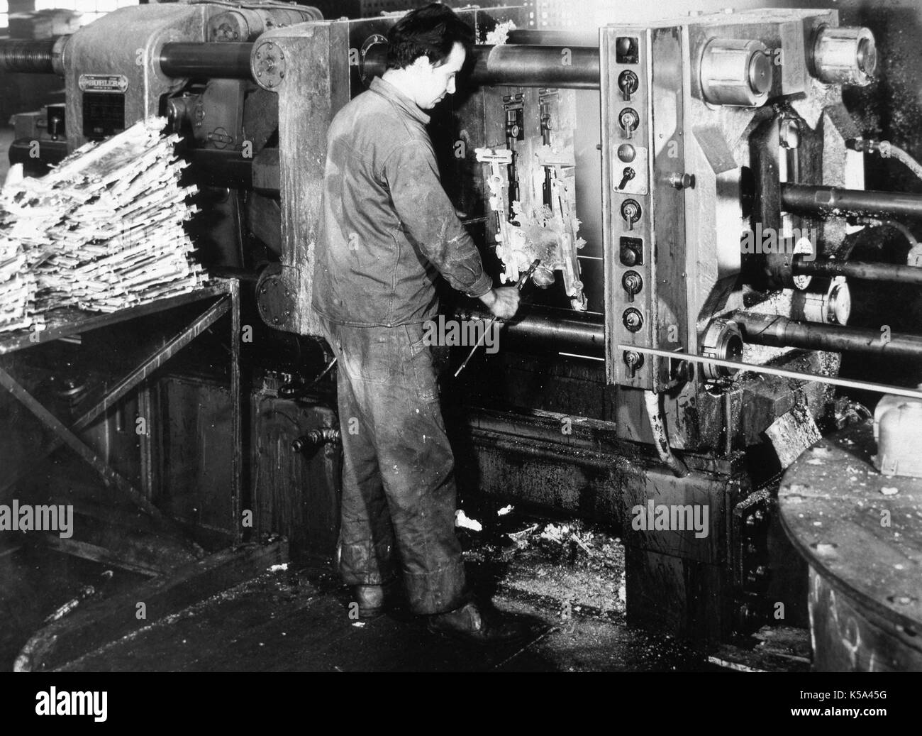 Spanish industry, 1962. Worker operating an aluminum injection machine. Metal stamping industry