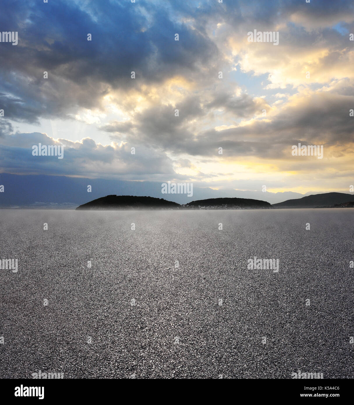Asphalt road with cloudy sky and mountain background Stock Photo - Alamy