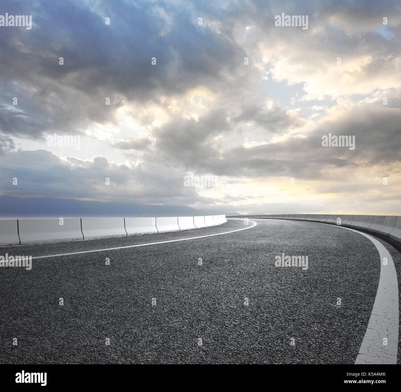 Asphalt road with cloudy sky and mountain background Stock Photo - Alamy