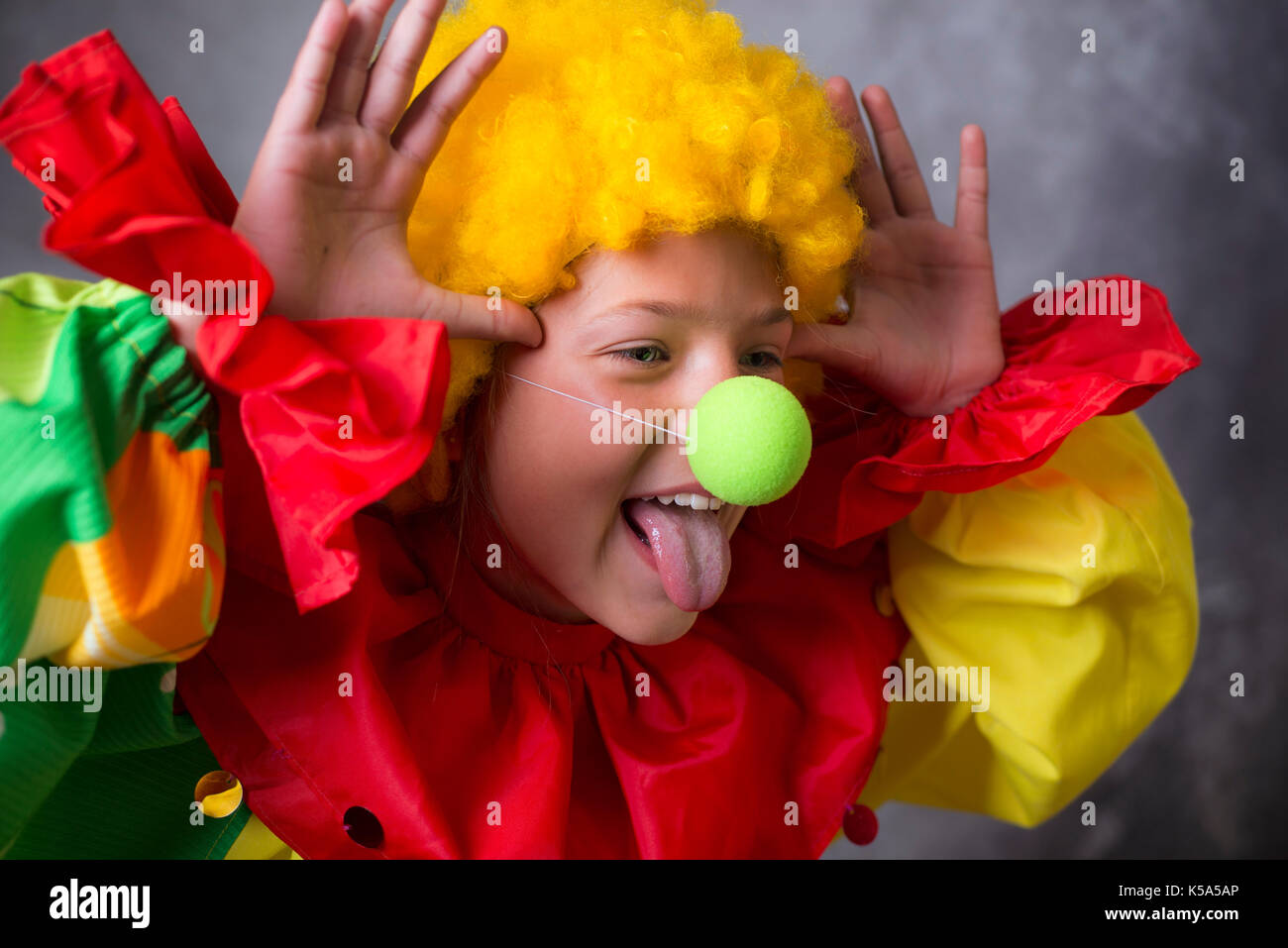 little clown showing tongue with funny grimace Stock Photo