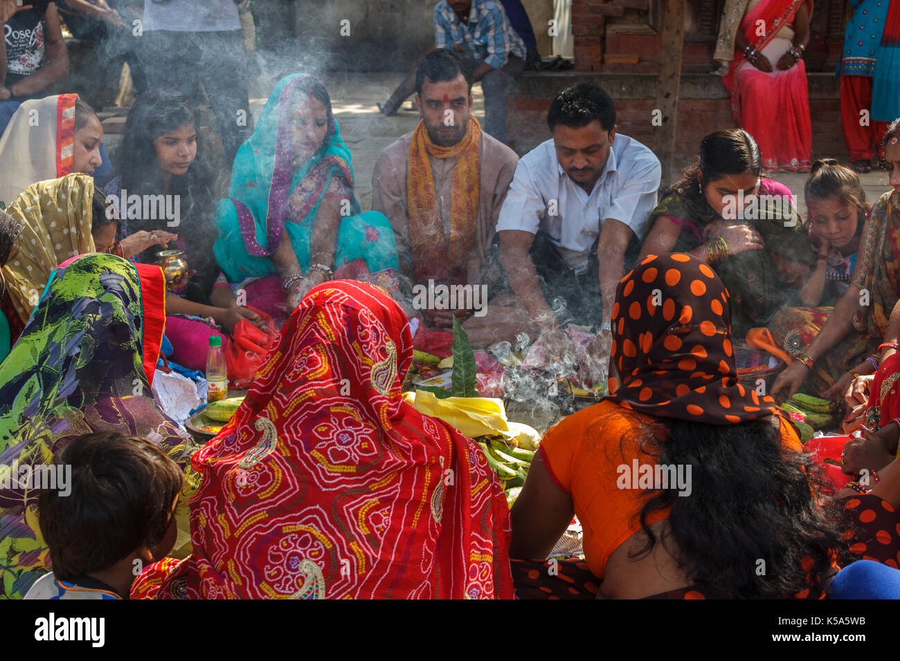 KATHMANDU, NEPAL - 9/26/2015: Hindu men and women in colorful sari sit in a circle at Durbar Square in Kathmandu, Nepal. Stock Photo