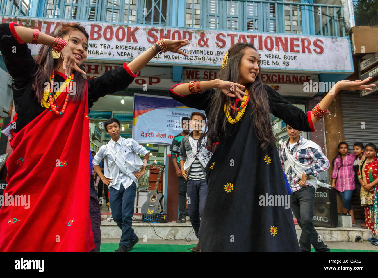 POKHARA, NEPAL - 11/9/2015: A group of young Nepalese performers dance in traditional clothes during the Tihar festival in Pokhara, Nepal. Stock Photo