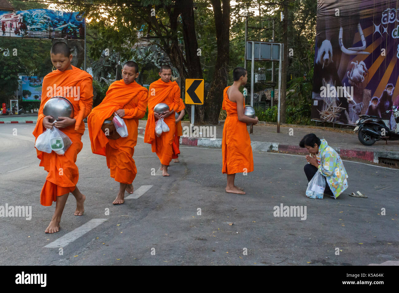 CHIANG MAI, THAILAND - 1/8/2016: Monks collect donations in Chiang Mai, Thailand. Stock Photo