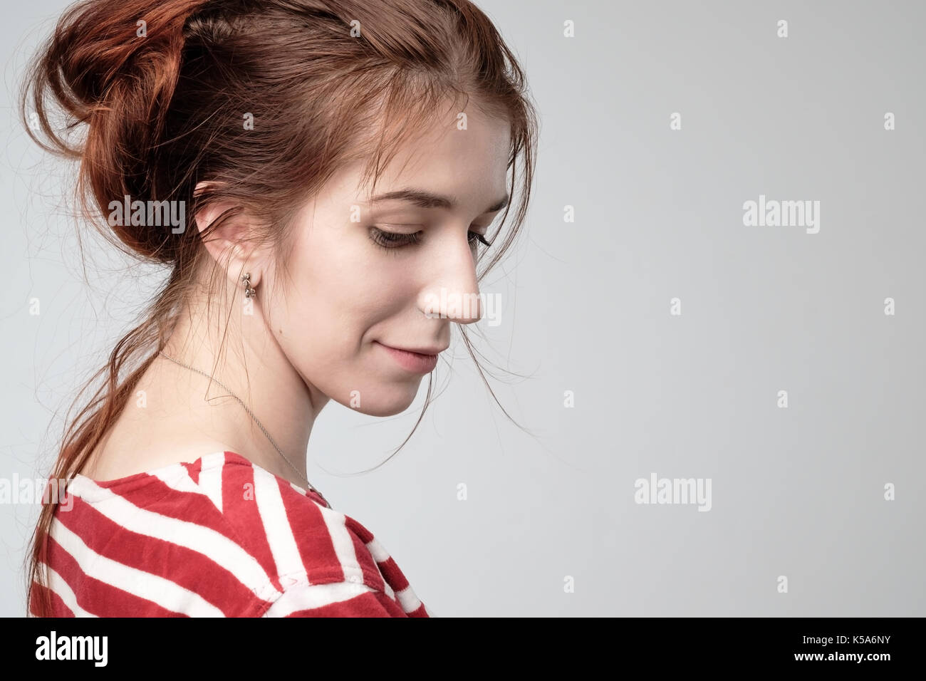 beautiful teenager girl with red hair side view. Stock Photo