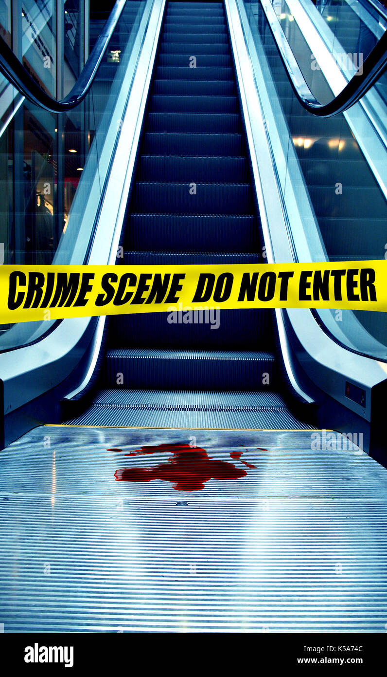 crime scene near an escalator with police tape and blood stain Stock Photo