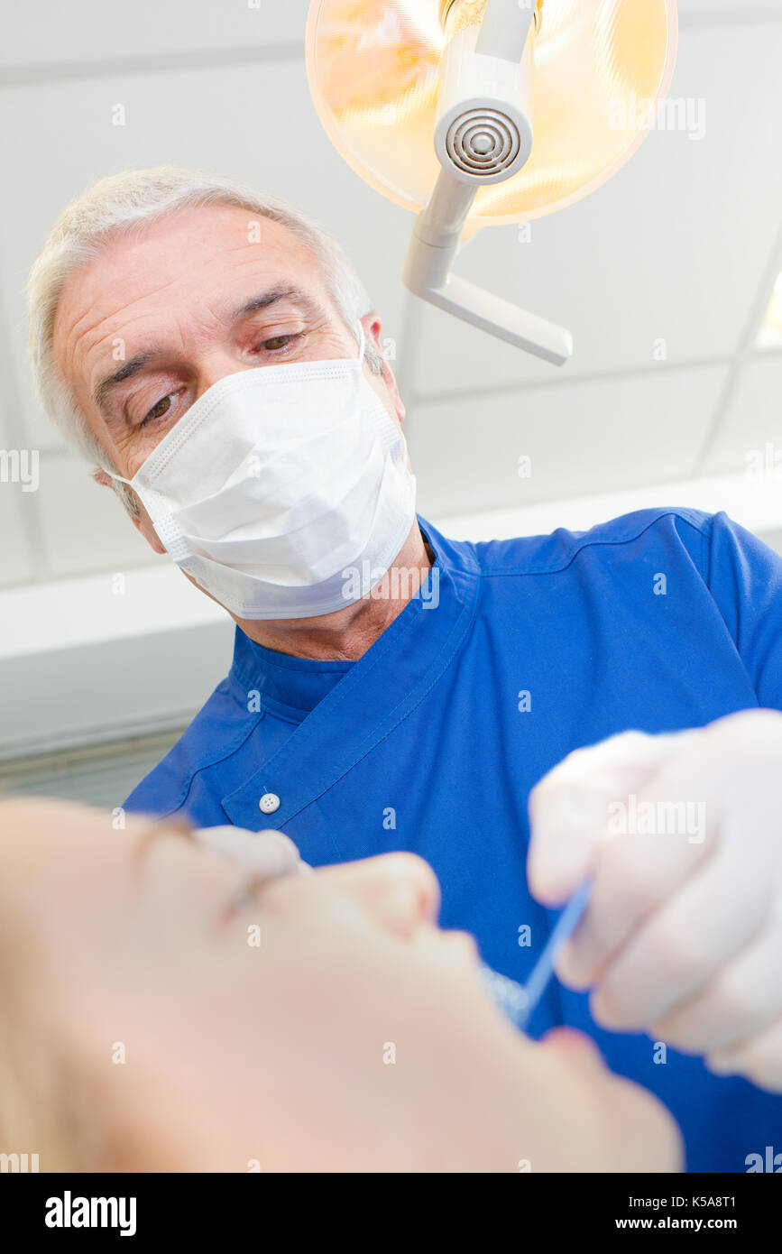 senior dentist taking care of females patients teeth Stock Photo Alamy