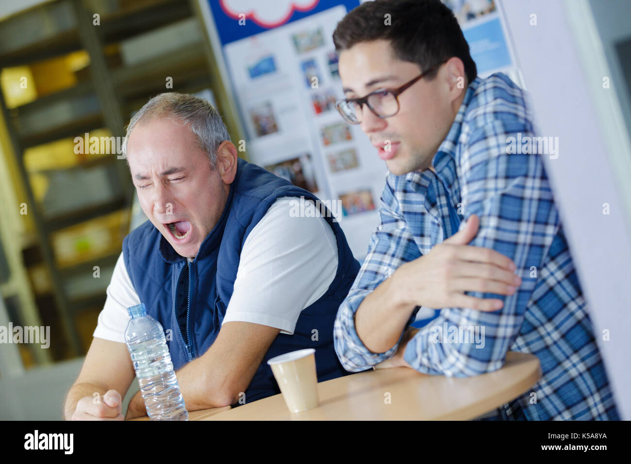 two attractive construction workers having a coffee break Stock Photo