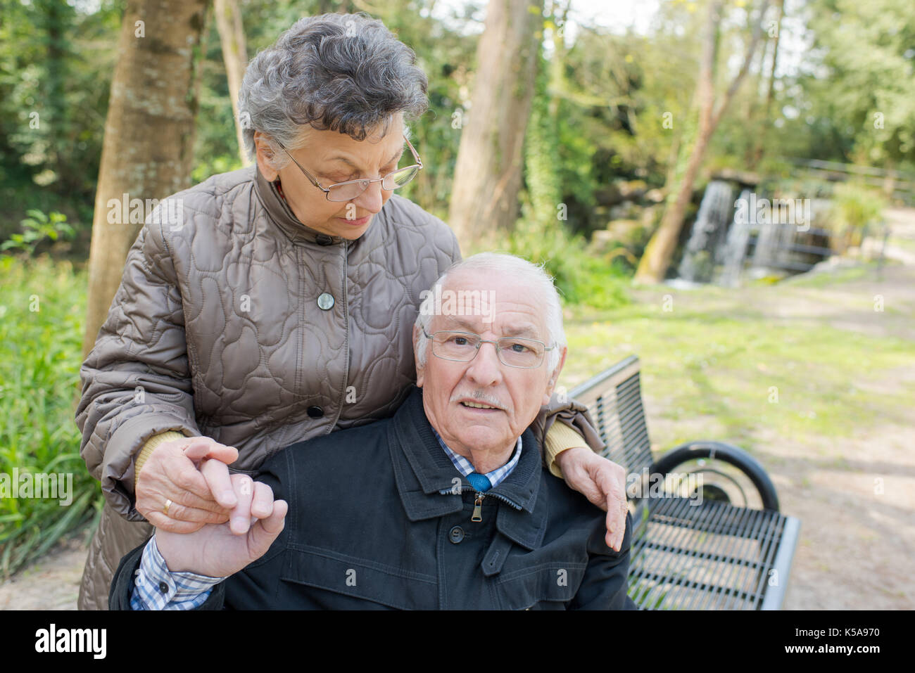 senior couple sitting outdoors on a park bench Stock Photo - Alamy