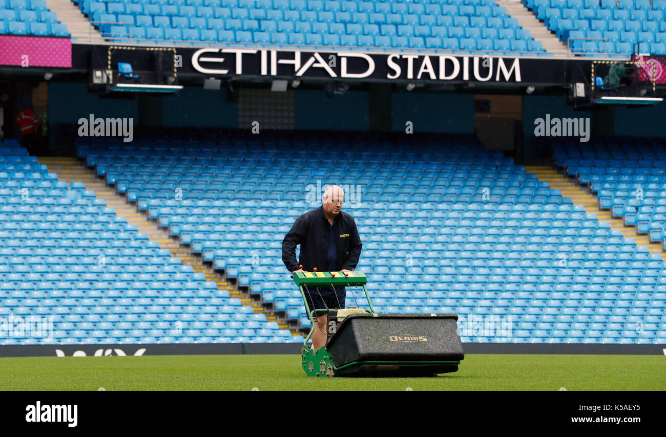 A groundsman prepares the pitch before the Premier League match between