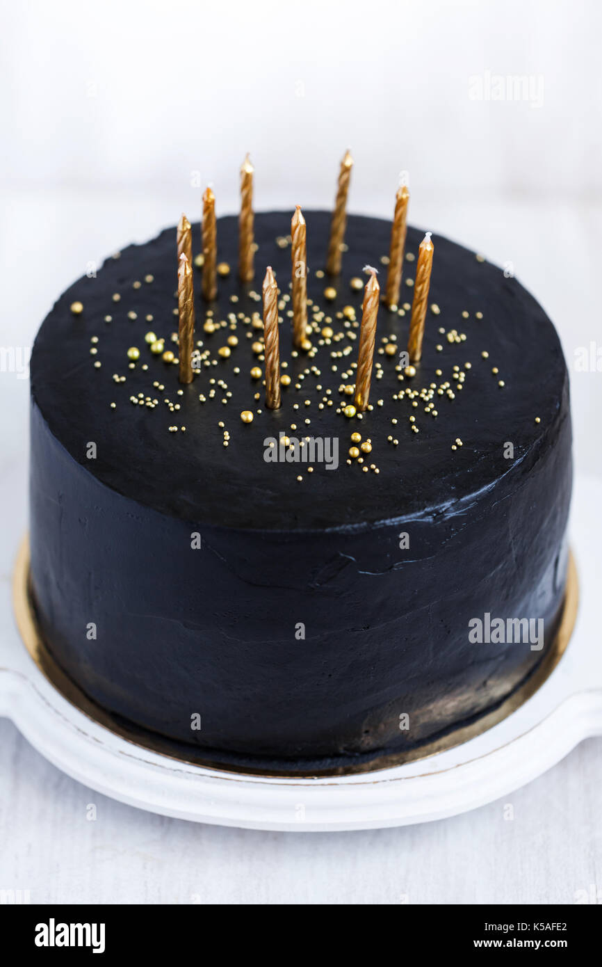Black Birthday Cake With Golden Candles On White Background Stock Photo Alamy