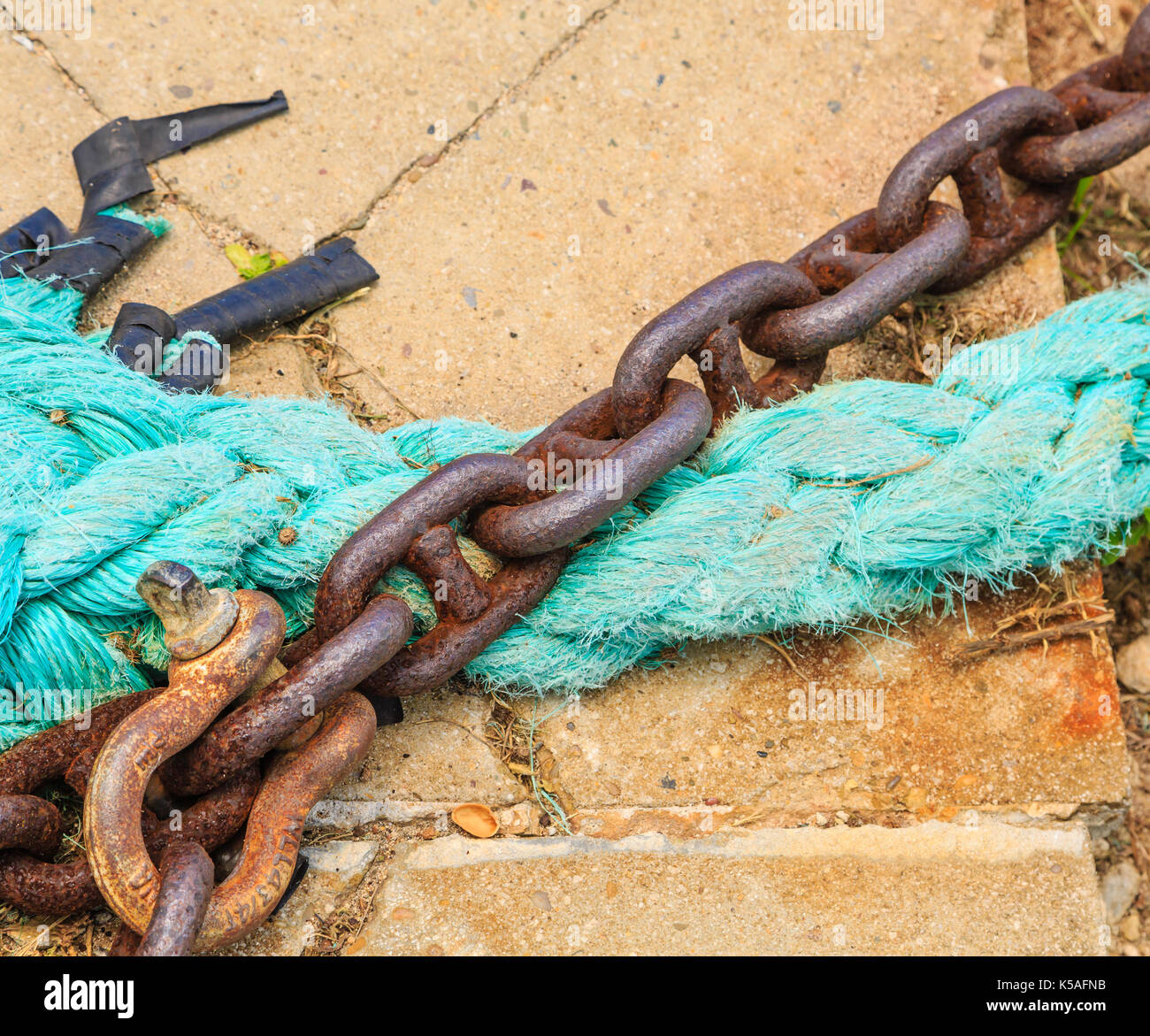 Rusty Rope Rusty Chain and Blue Rope on Concrete Pier Stock Photo - Alamy