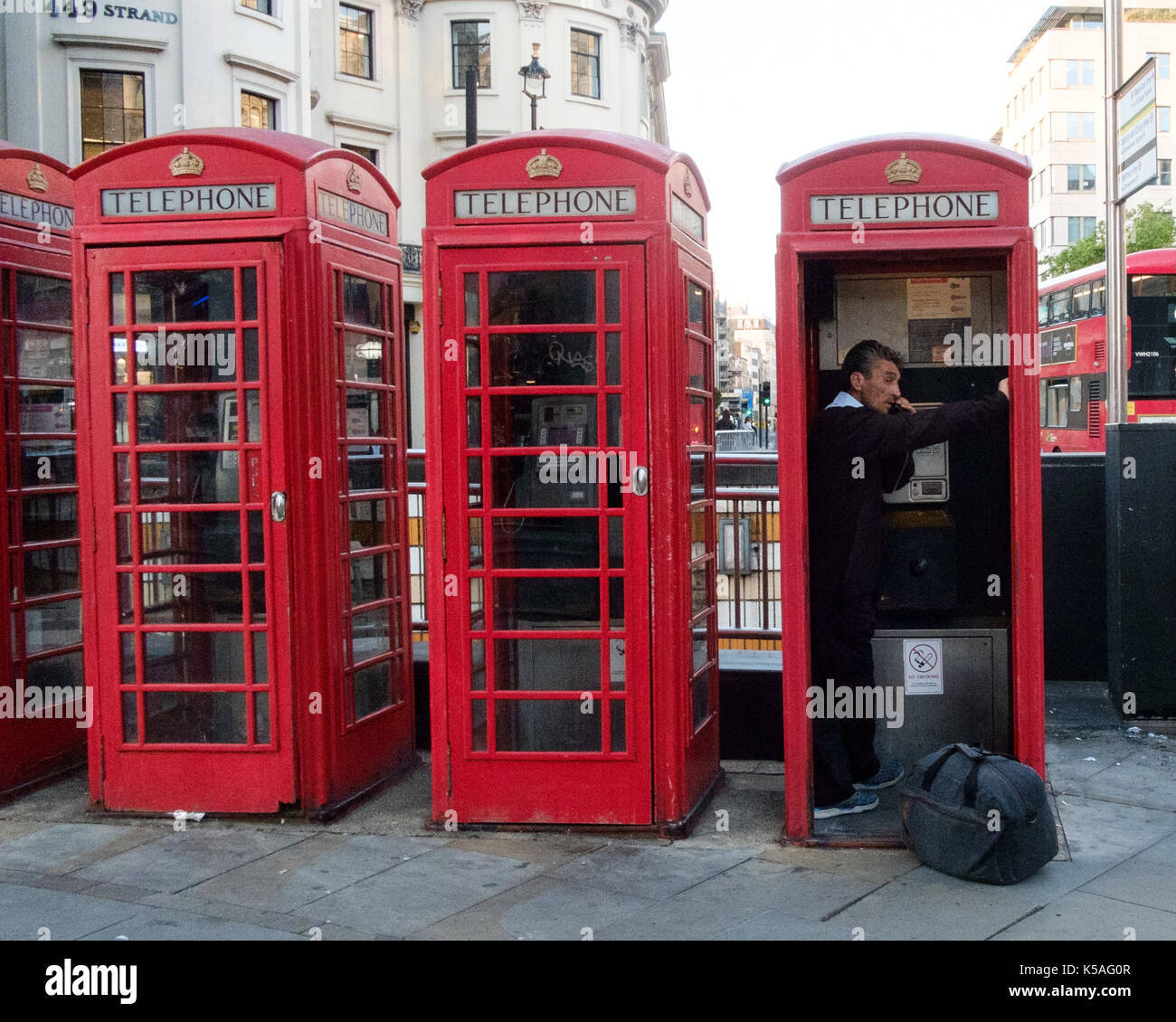 Man Using Red Telephone Vintage telephone man hi-res stock photography and images - Alamy
