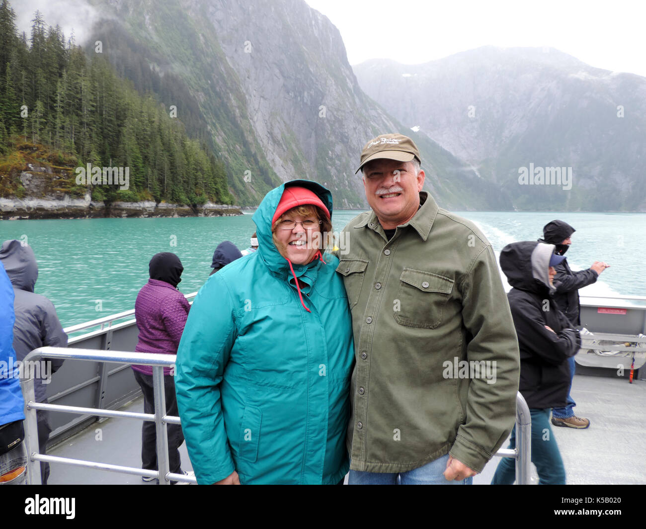 COUPLE POSING FOR PHOTOGRAPH ON SHIP DECK, ALASKA Stock Photo