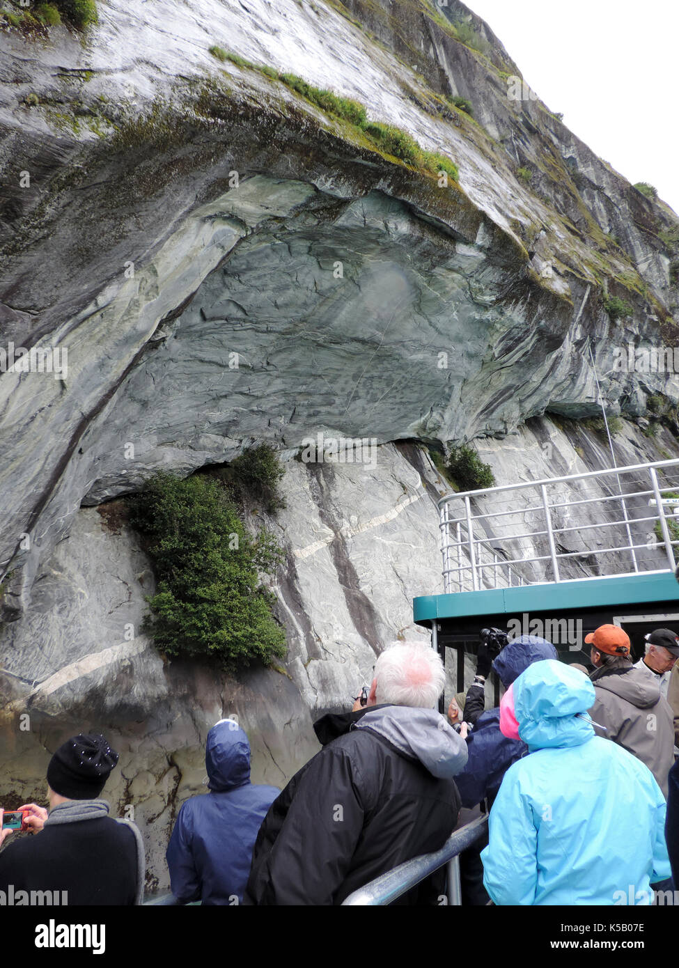 TOUR SHOWING SMOOTH CLIFFS FROM GLACIAL MOVEMENT, ALASKA Stock Photo