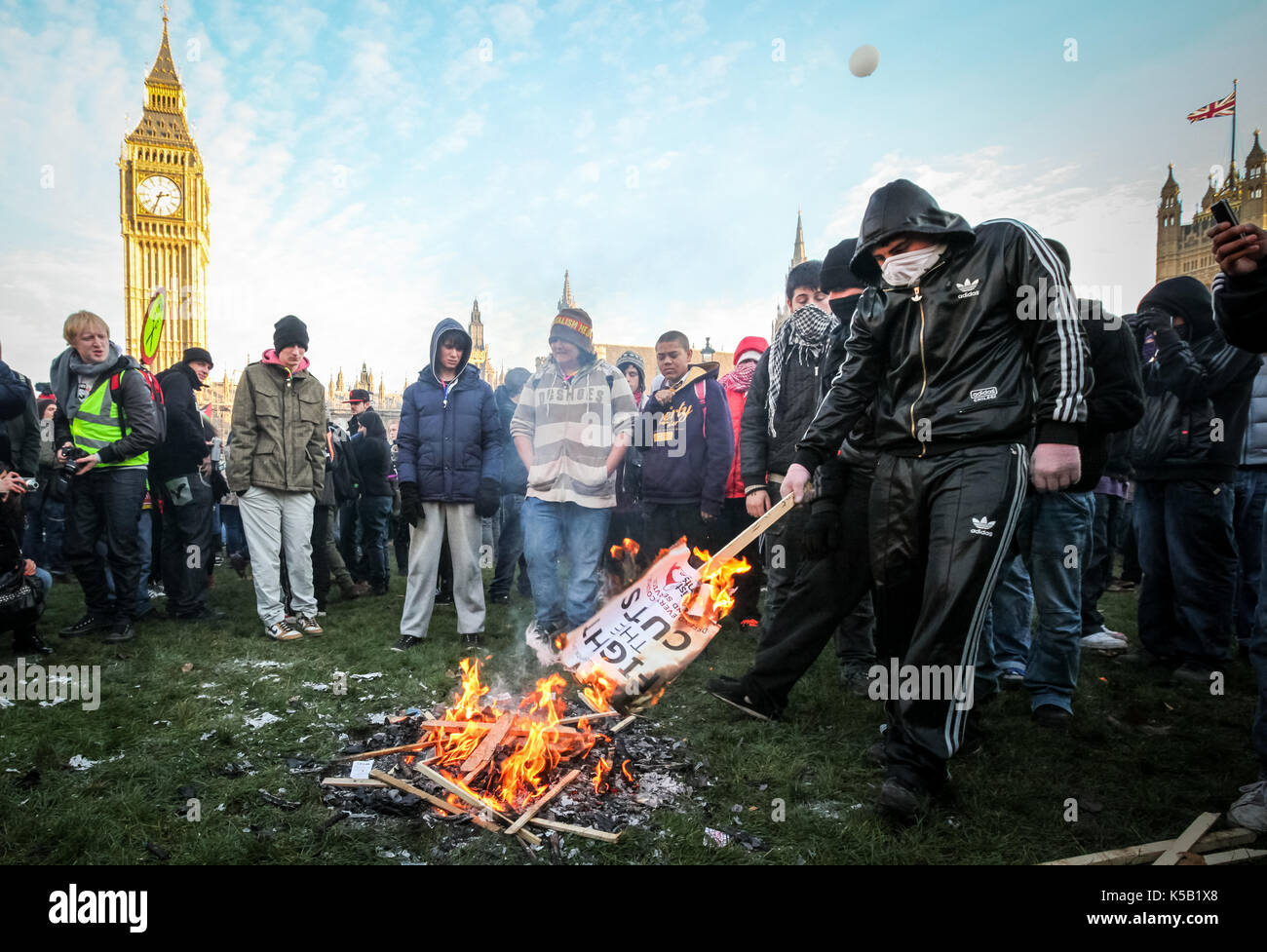 Burning placards. Mass student protests and civil unrest in London against increases in university tuition fees. Stock Photo
