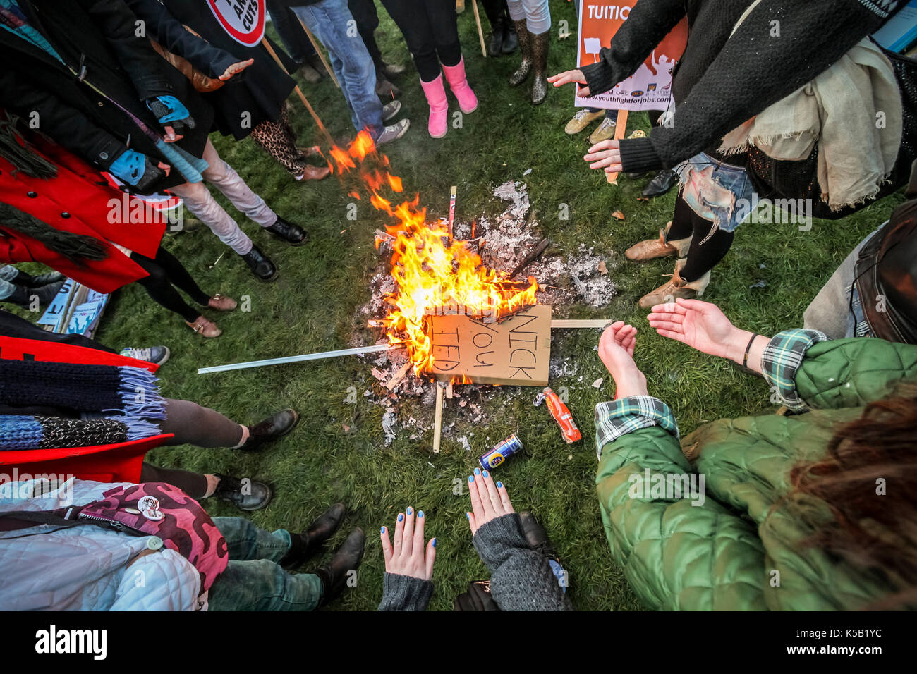 Burning placards. Mass student protests and civil unrest in London against increases in university tuition fees. Stock Photo