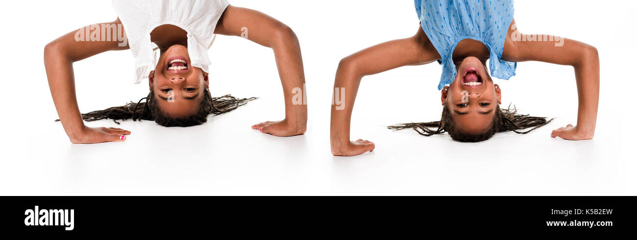 twin girls upside down on a white background Stock Photo