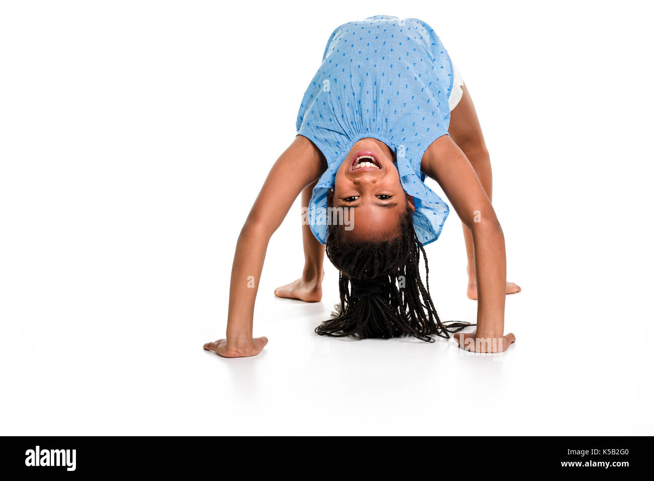 little girl upside down on a white background Stock Photo
