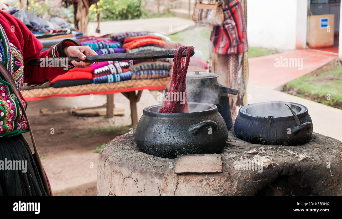 A Quechuan woman demsontrates alpaca wool weaving. Stock Photo