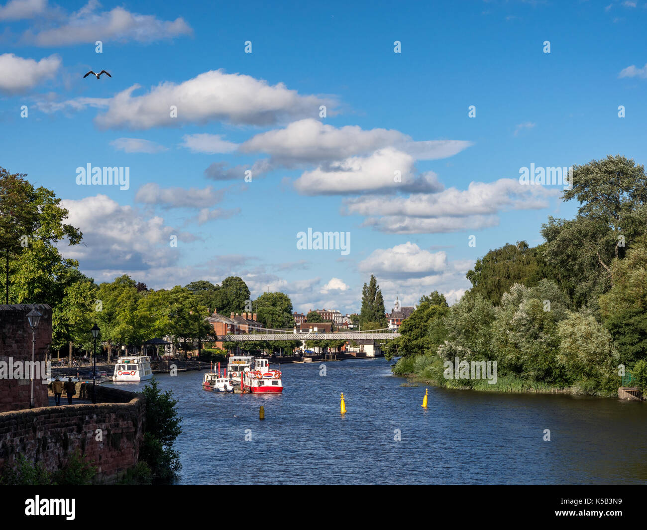 Panorama of River and Roman Walls in Chester UK showing the river,the roman city walls and part of the Old Bridge with a church in the background. Stock Photo
