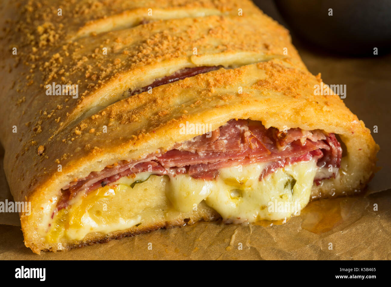 Homemade Cheesy and Meaty Italian Stromboli with Marinara Sauce Stock Photo